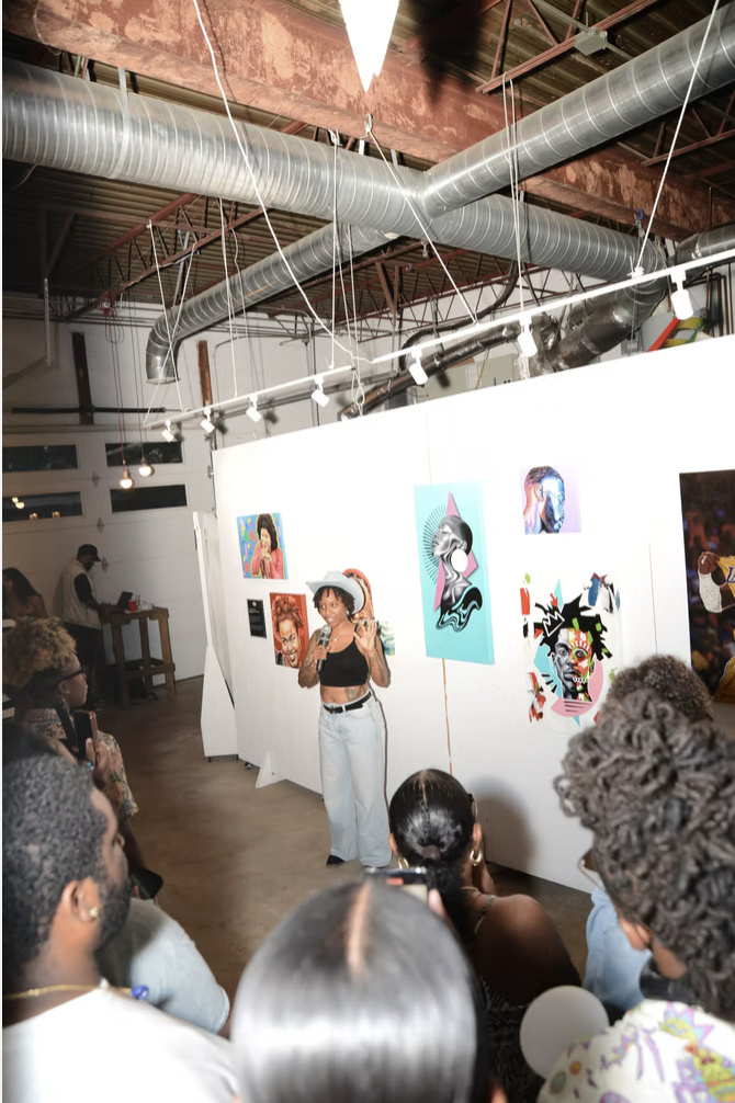 An artist presenting work to the community